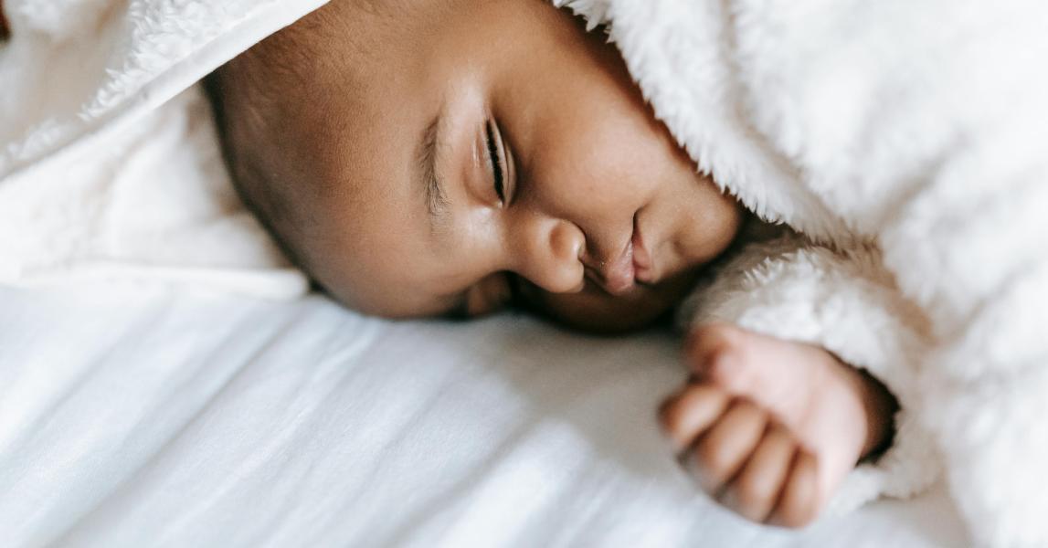 Baby sleeping on bed